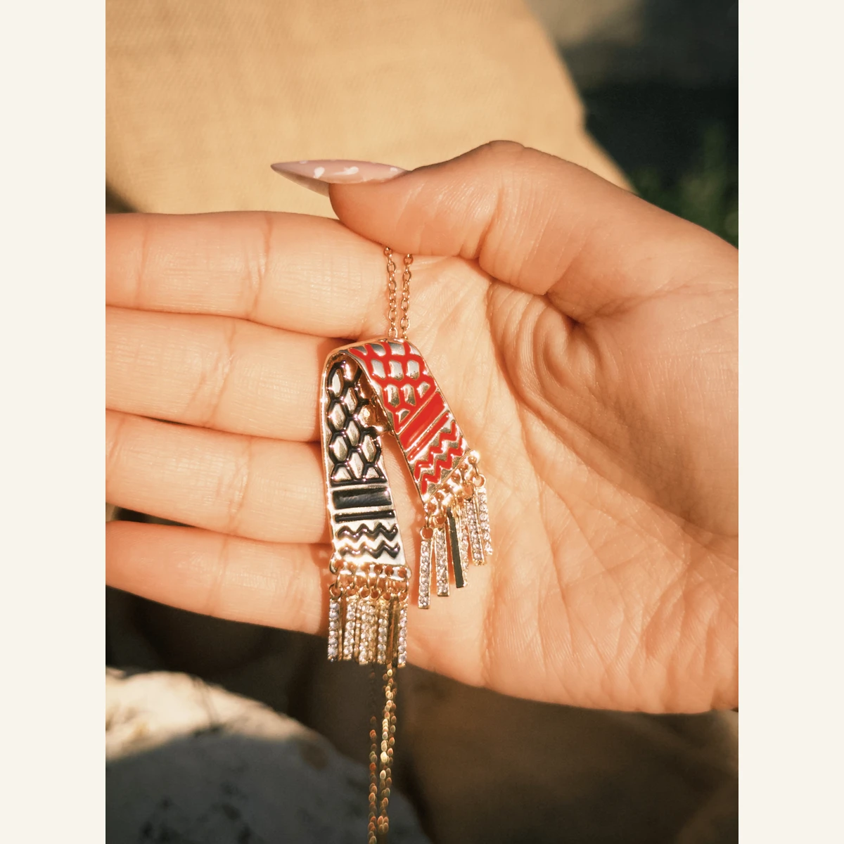 Red Keffiyeh Scarf Necklace held in hand to show its size