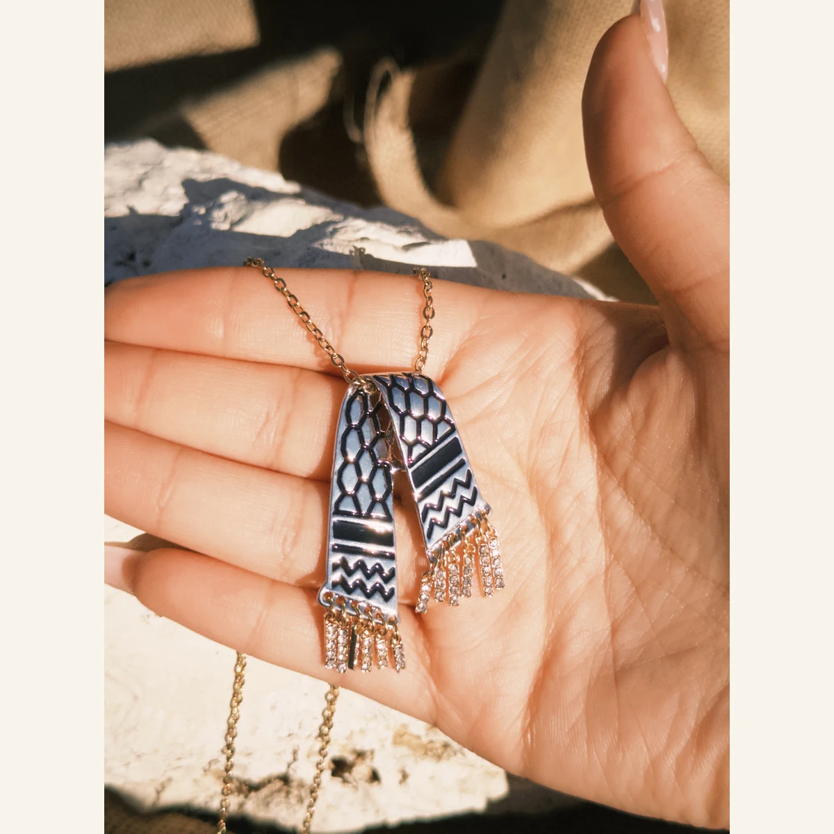 Black Keffiyeh Scarf Necklace held in hand to show its size
