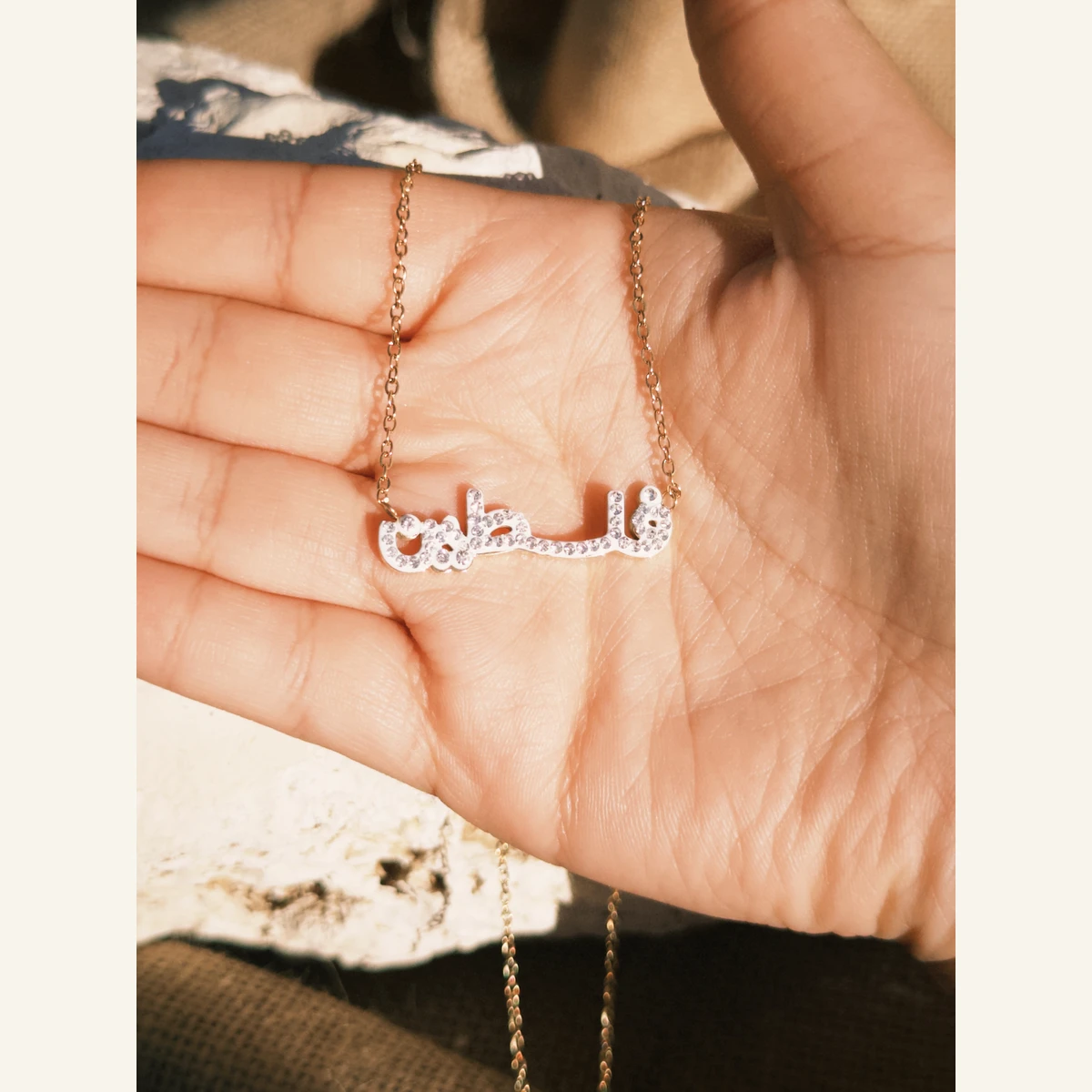Sparkling Filastin Necklace held in hand to show its size