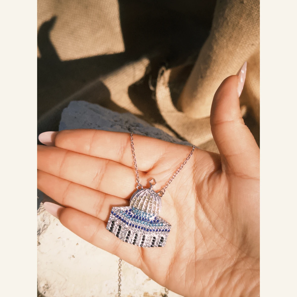 Silver-Tone Dome Necklace held in hand to show its size