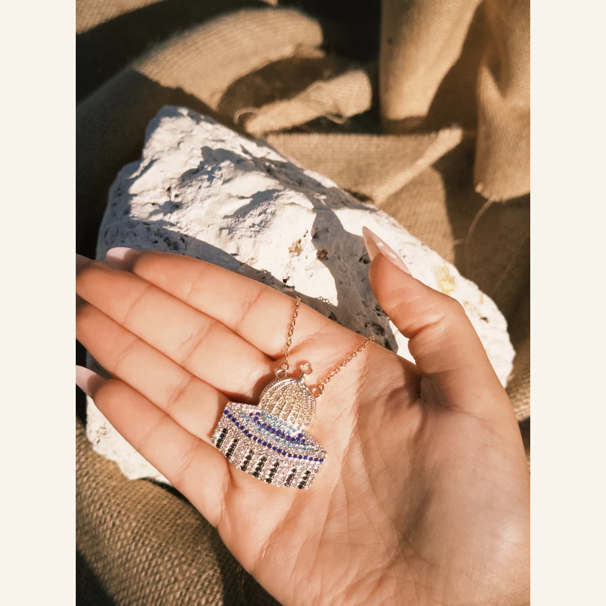 Golden Palestinian Dome Necklace held in hand to show its size