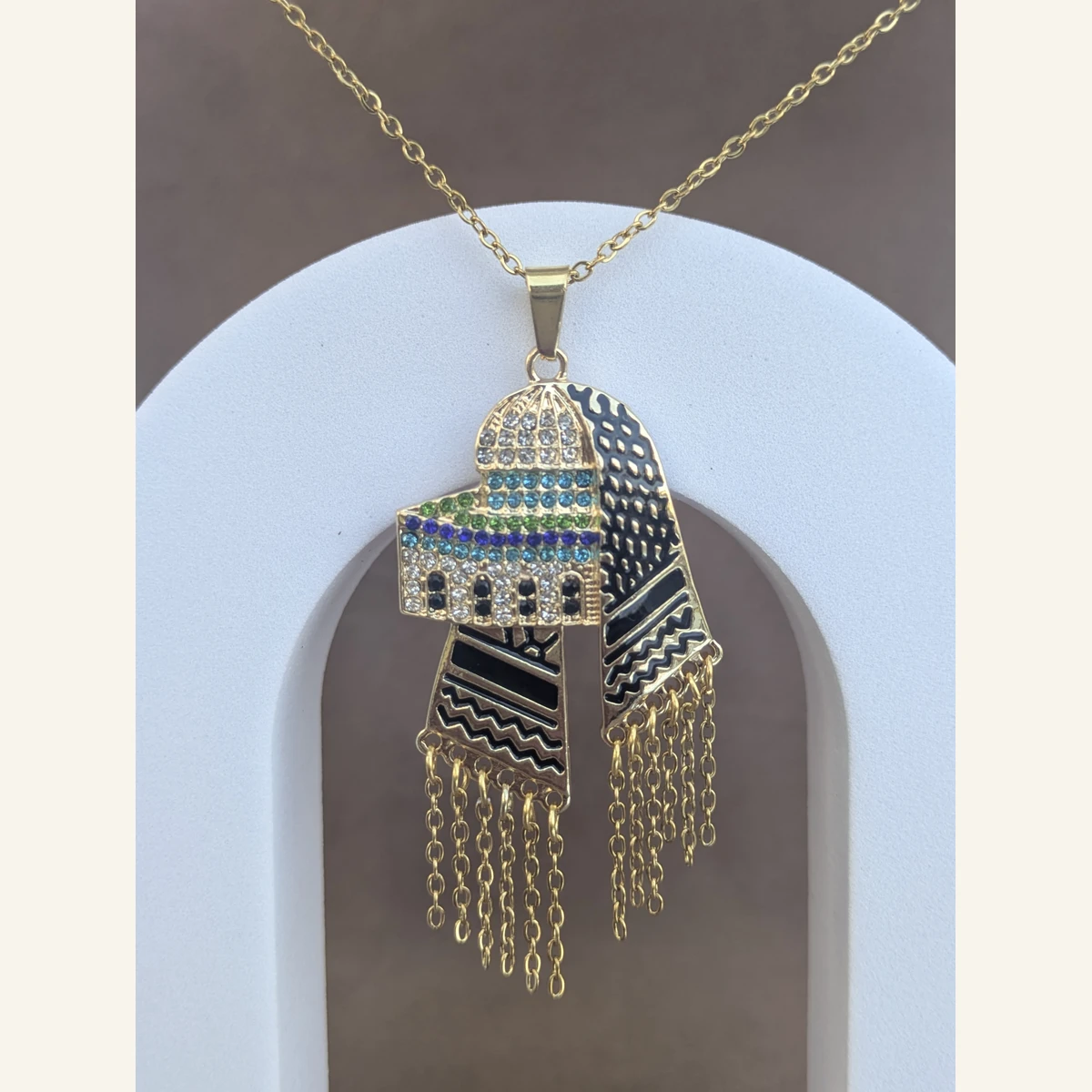 Golden Dome Keffiyeh Necklace held in hand to show its size