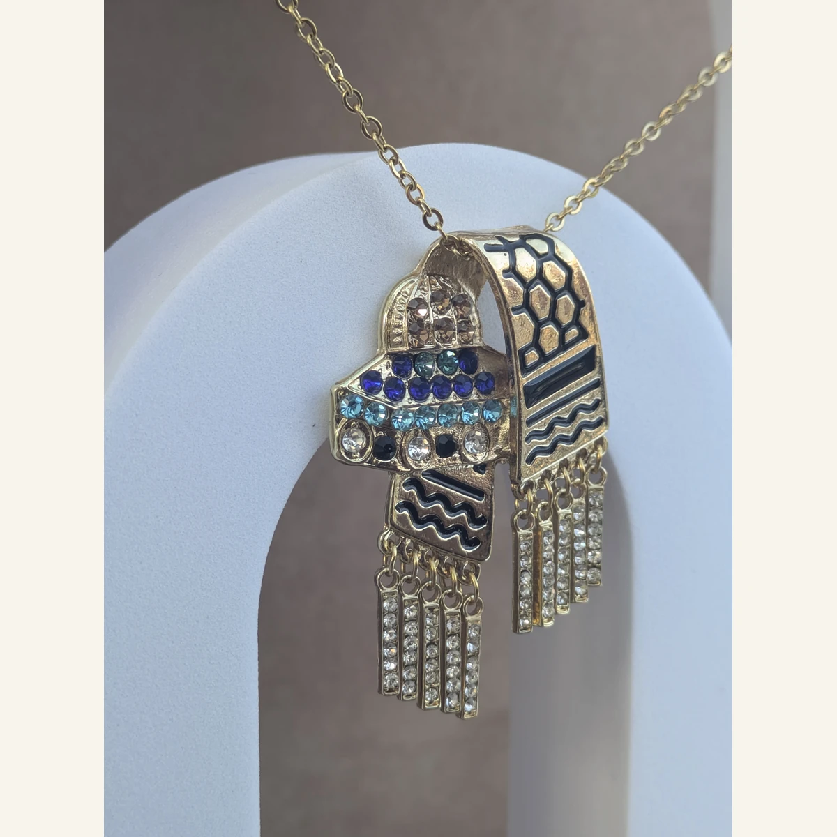 Twin Dome Keffiyeh Necklace held in hand to show its size