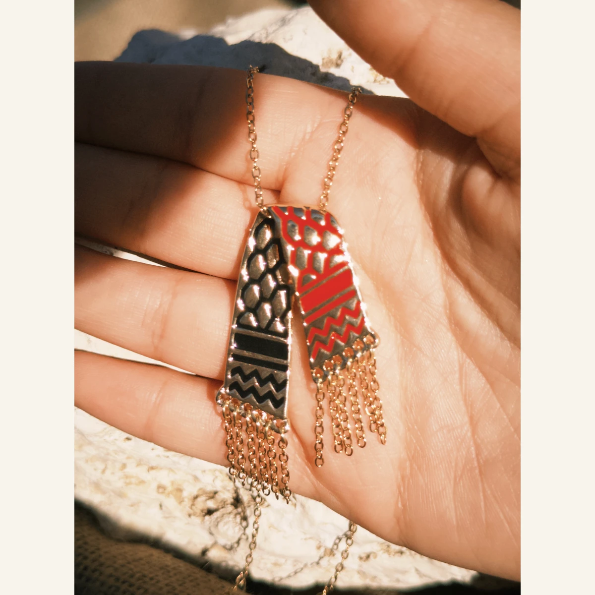 Red Tassel Keffiyeh Necklace held in hand to show its size