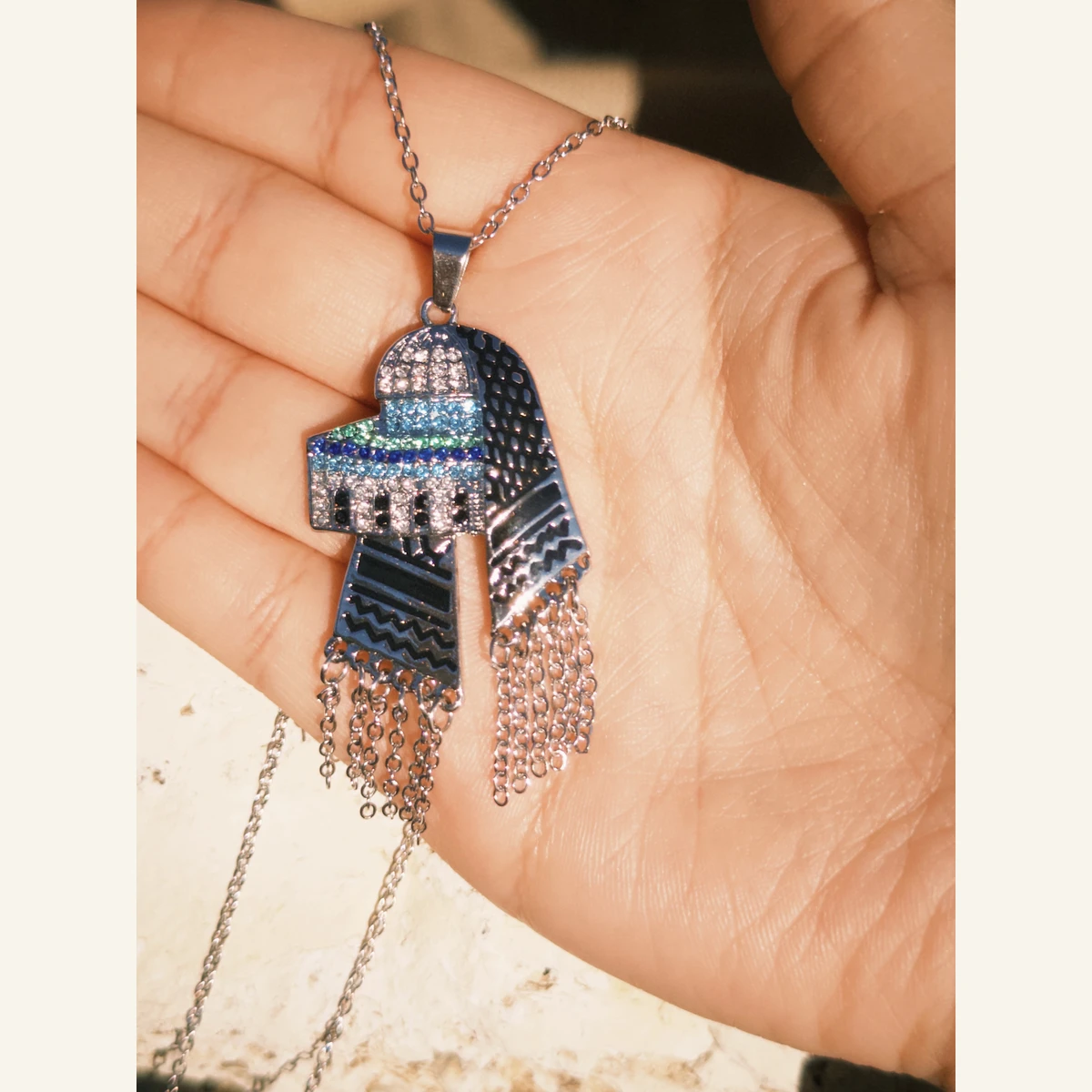 Palestinian Dome Tassel Necklace held in hand to show its size