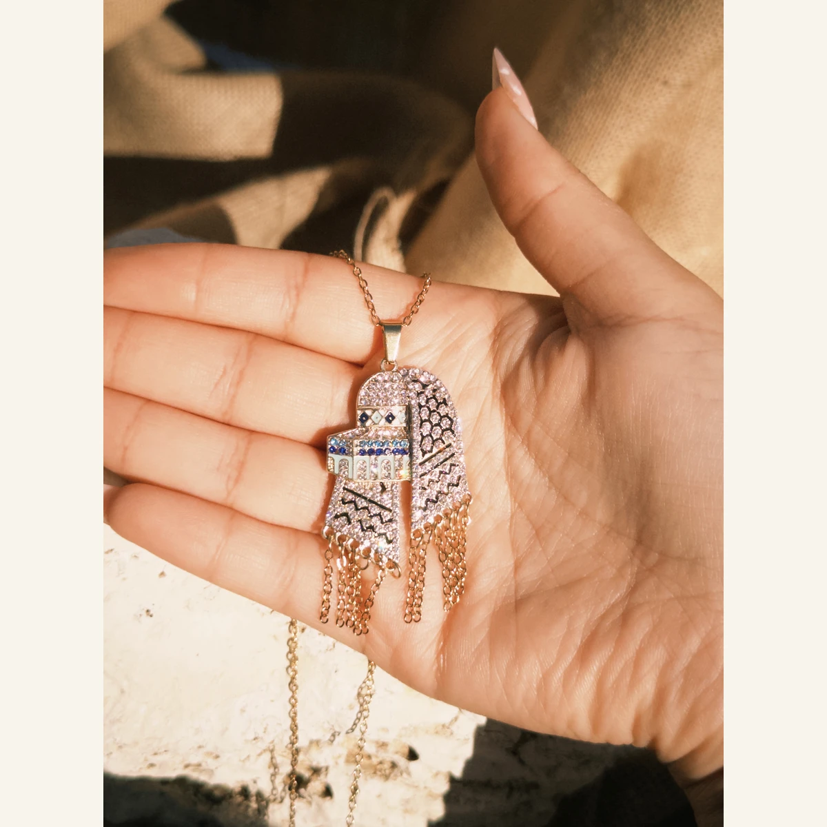 Sparkling Dome Keffiyeh Necklace held in hand to show its size