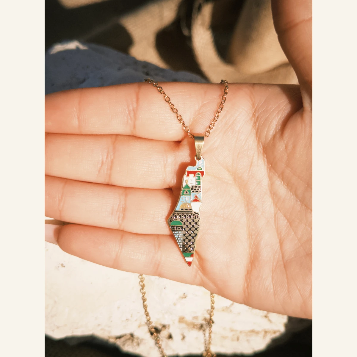 Green Palestine Mosaic Necklace held in hand to show its size